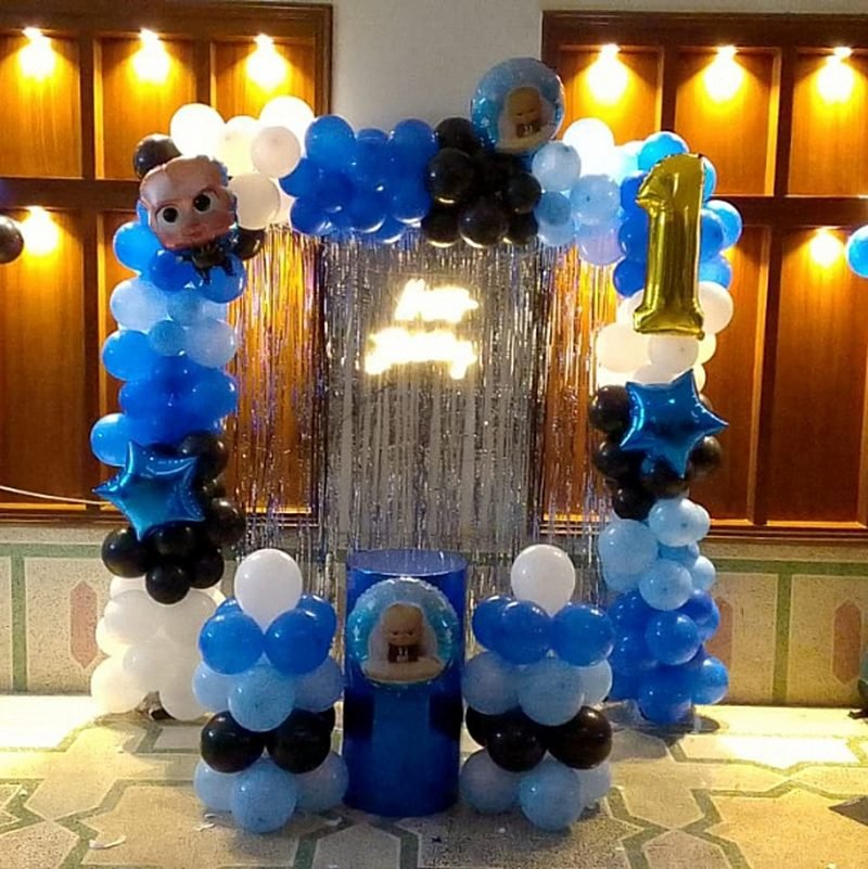 Blue, black and silver first birthday setup with a balloon column and gold number 1 – Events In Sialkot