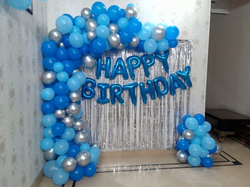 Blue and silver balloon arch with Happy Birthday foil letters and silver curtain – Events In Sialkot