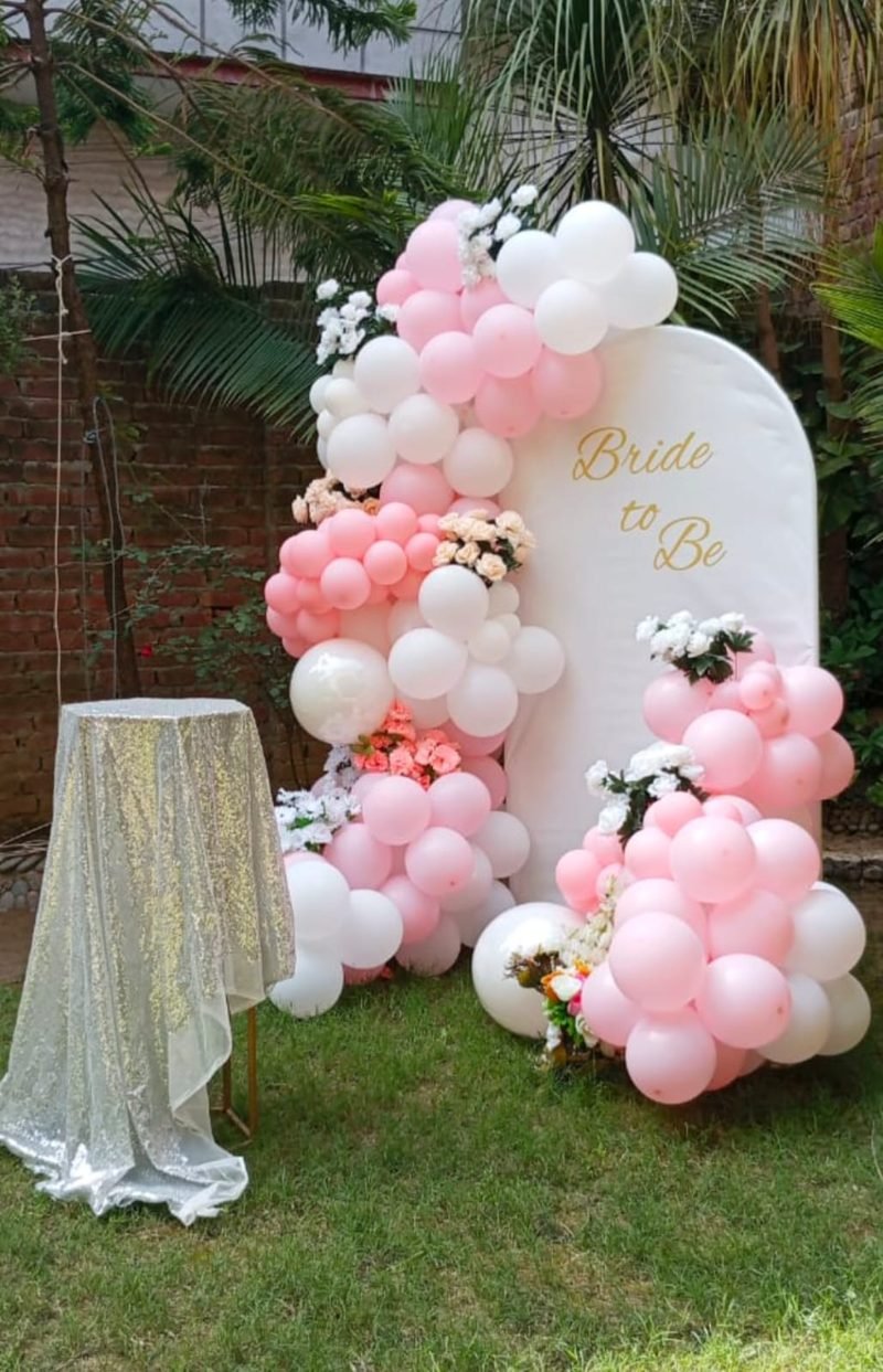 Garden Bride to Be setup with a white arch, pink balloons and flowers – Events In Sialkot