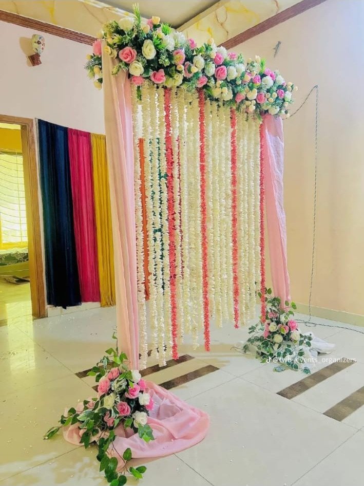 White and orange floral backdrop decor with fairy lights in Sialkot – Events In Sialkot