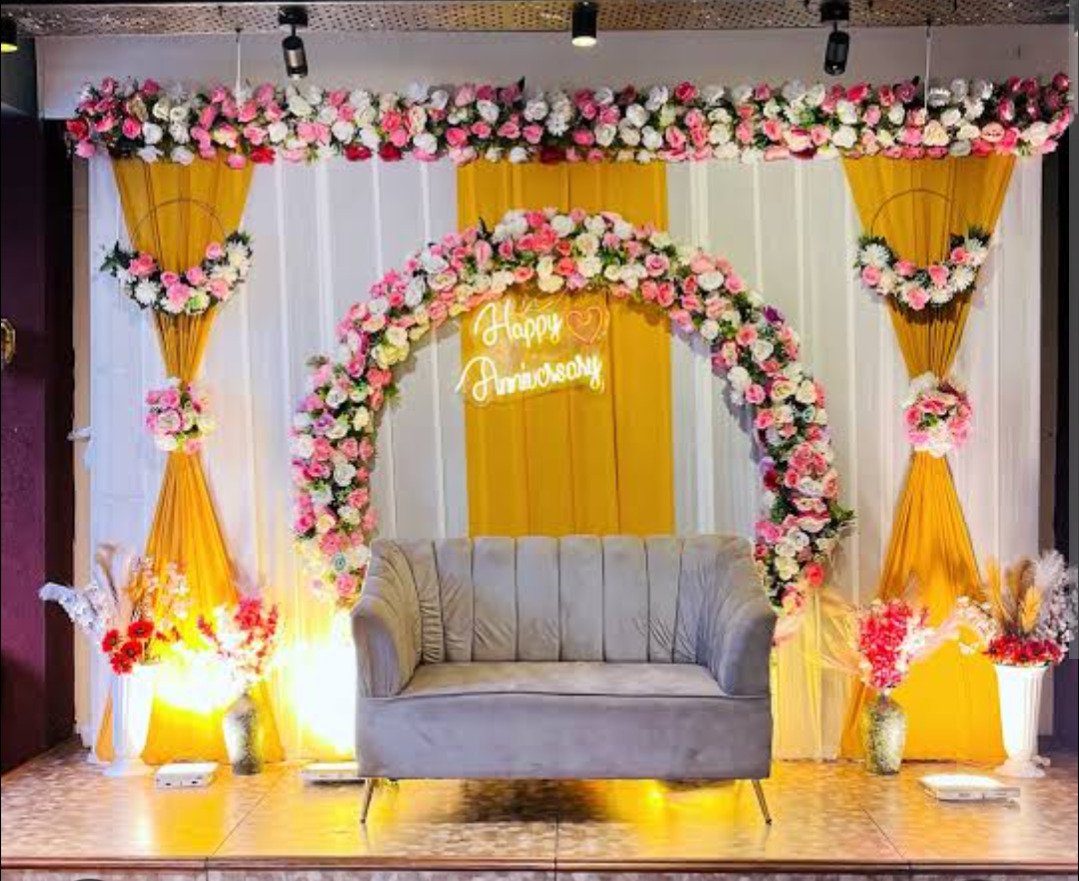 Orange and gold floral backdrop decor with fairy lights in Sialkot – Events In Sialkot