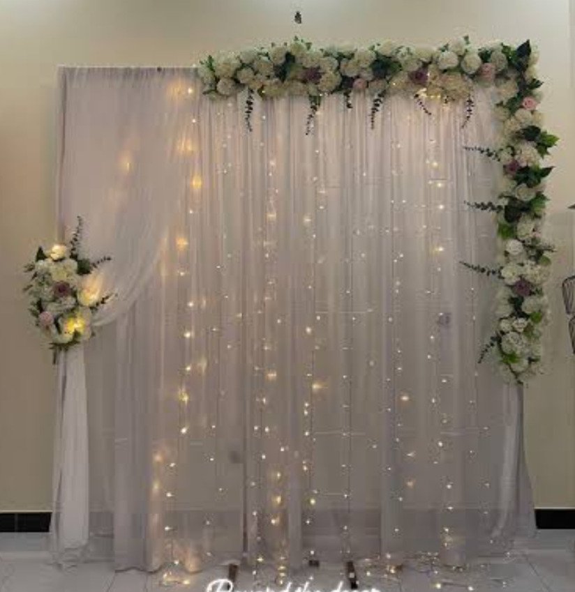 White and orange floral backdrop decor with fairy lights in Sialkot – Events In Sialkot