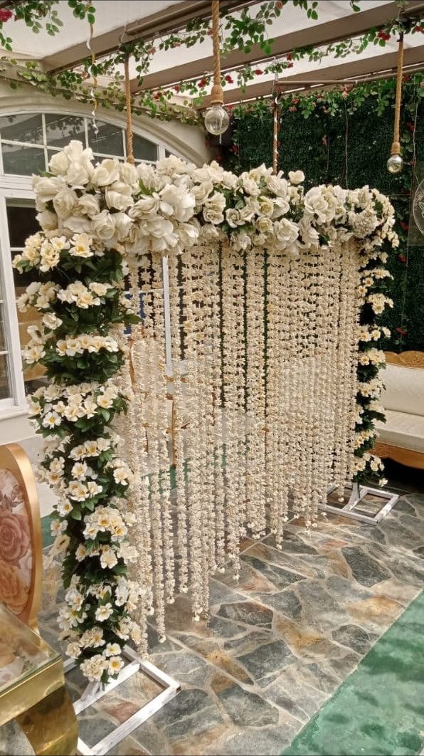 White and orange floral backdrop decor with fairy lights in Sialkot – Events In Sialkot
