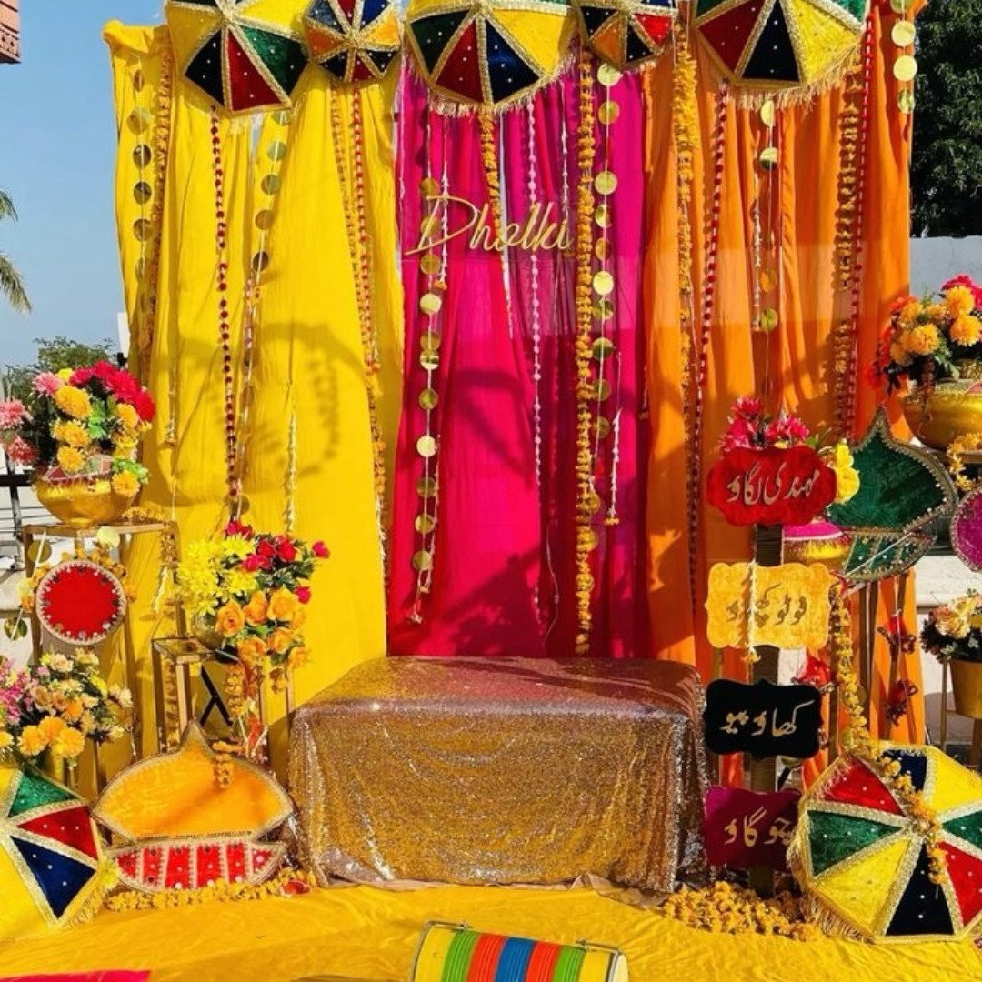 Gold and orange mehndi stage decoration in Sialkot – Events In Sialkot