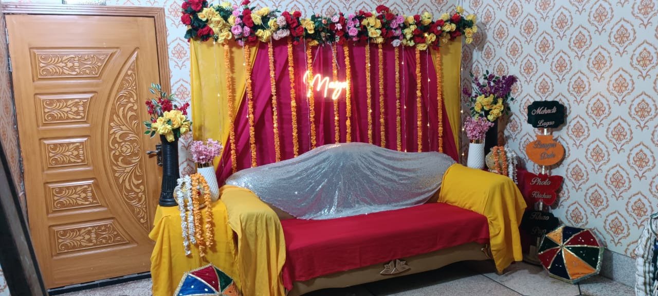 Orange and maroon mehndi stage decoration in Sialkot – Events In Sialkot