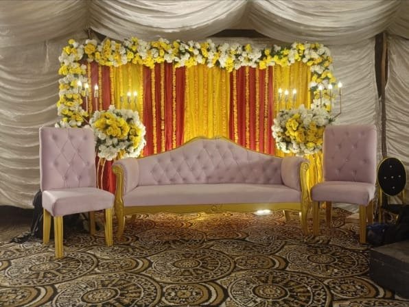 Gold and orange mehndi stage decoration in Sialkot – Events In Sialkot