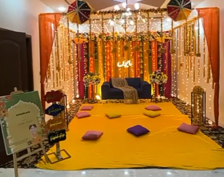 Orange and gold mehndi stage decoration in Sialkot – Events In Sialkot