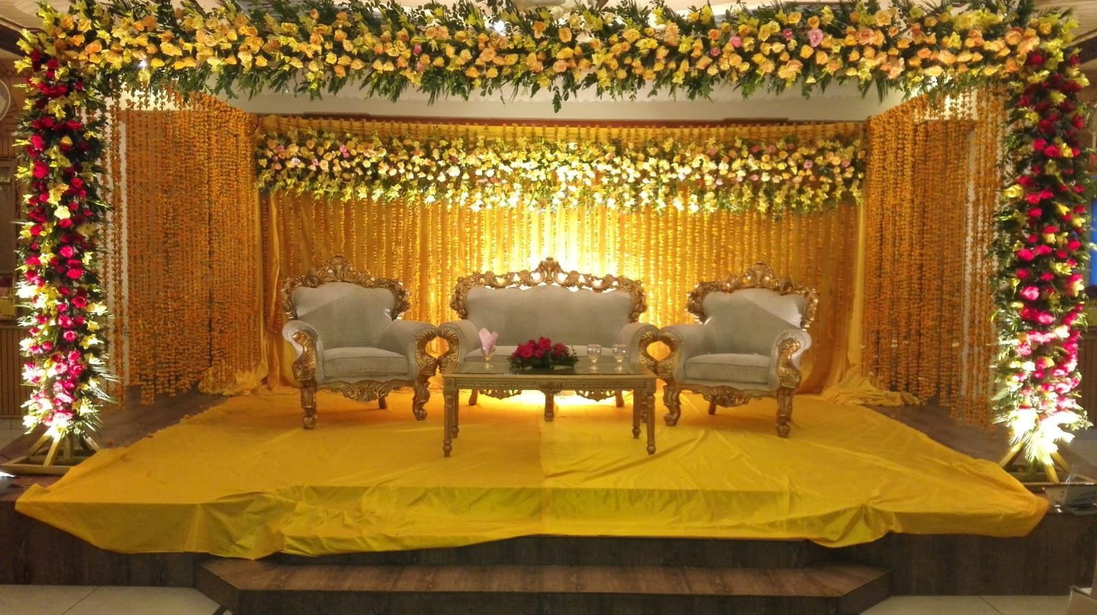 Gold and orange mehndi stage decoration in Sialkot – Events In Sialkot