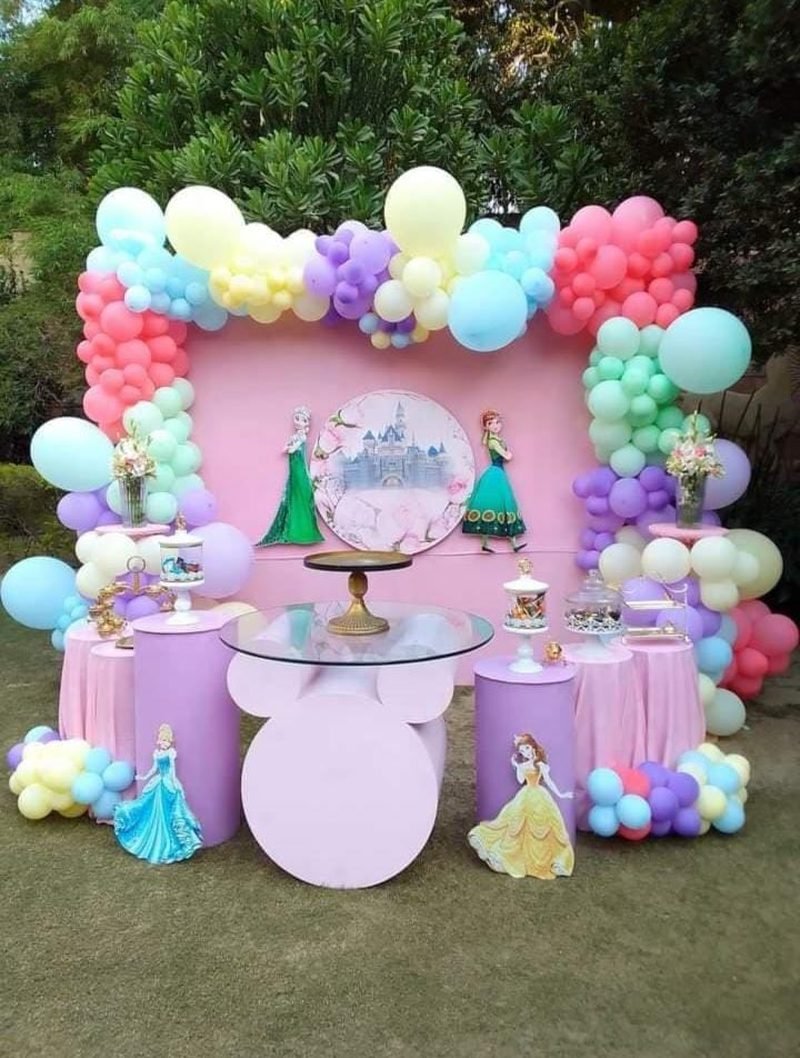 Kids party setup in Sialkot with pastel balloon frame, pink backdrop and character cut-outs